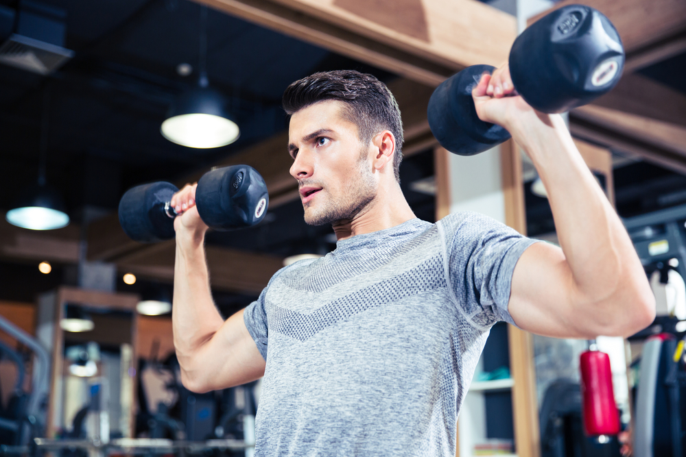 Portrait of a fitness man workout with dumbbells at gym-3