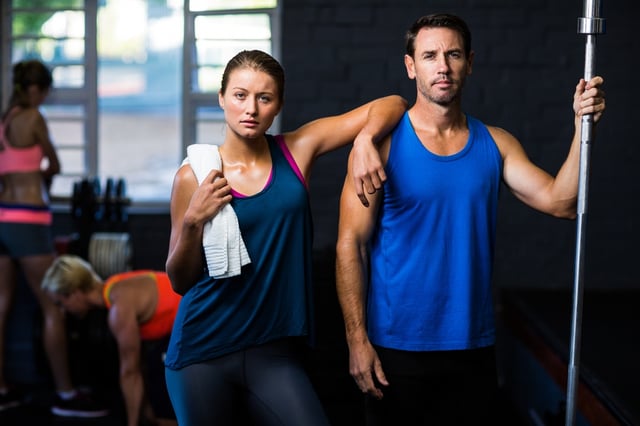 Portrait of fit serious friends standing in gym.jpeg