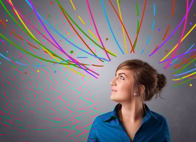 Pretty young girl thinking with colorful abstract lines overhead.jpeg