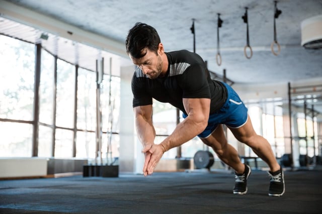 Sportsman wearing blue shorts and black t-shirt doing push-up with claping.jpeg